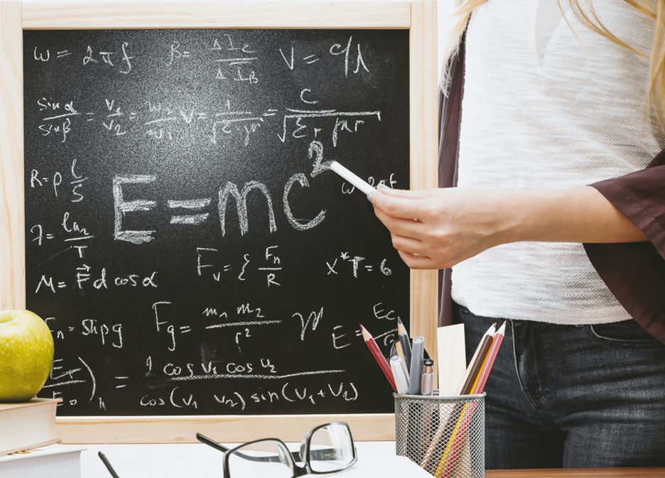 A person standing in front of a chalkboard