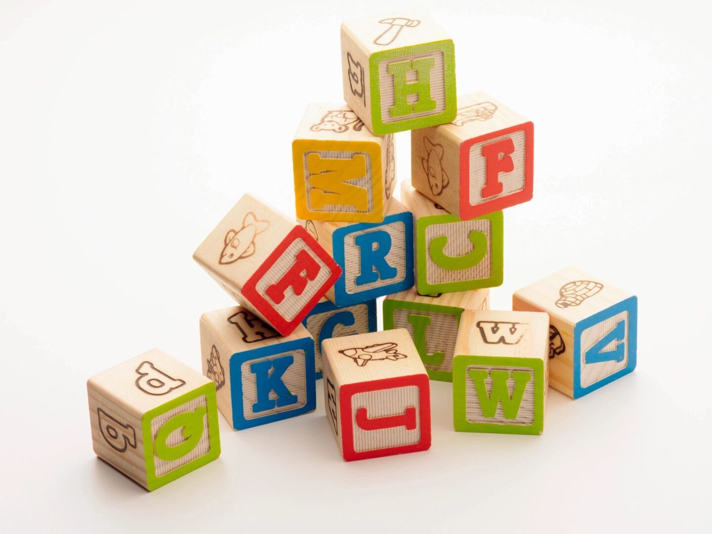 A pile of wooden blocks with letters on them.